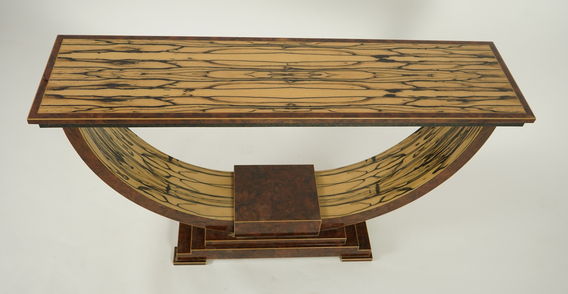 An Art Deco style white ebony and walnut console table